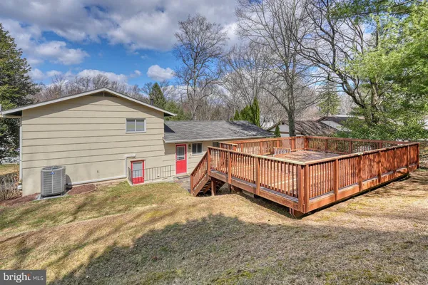 a view of a house with a yard and wooden fence