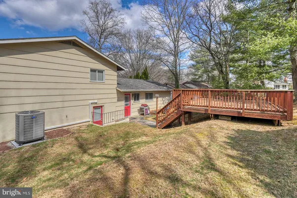 a view of backyard with deck and seating space