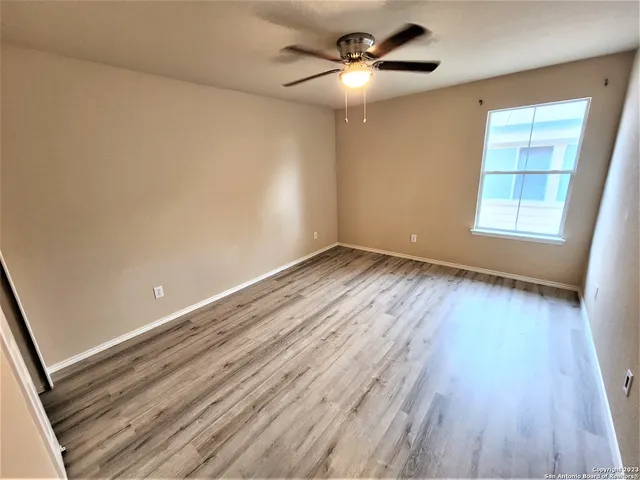 wooden floor in an empty room with a window