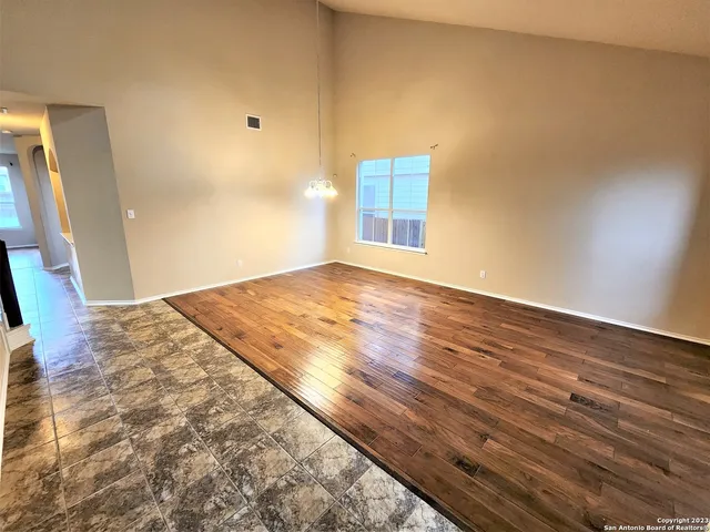 a view of an empty room and wooden floor