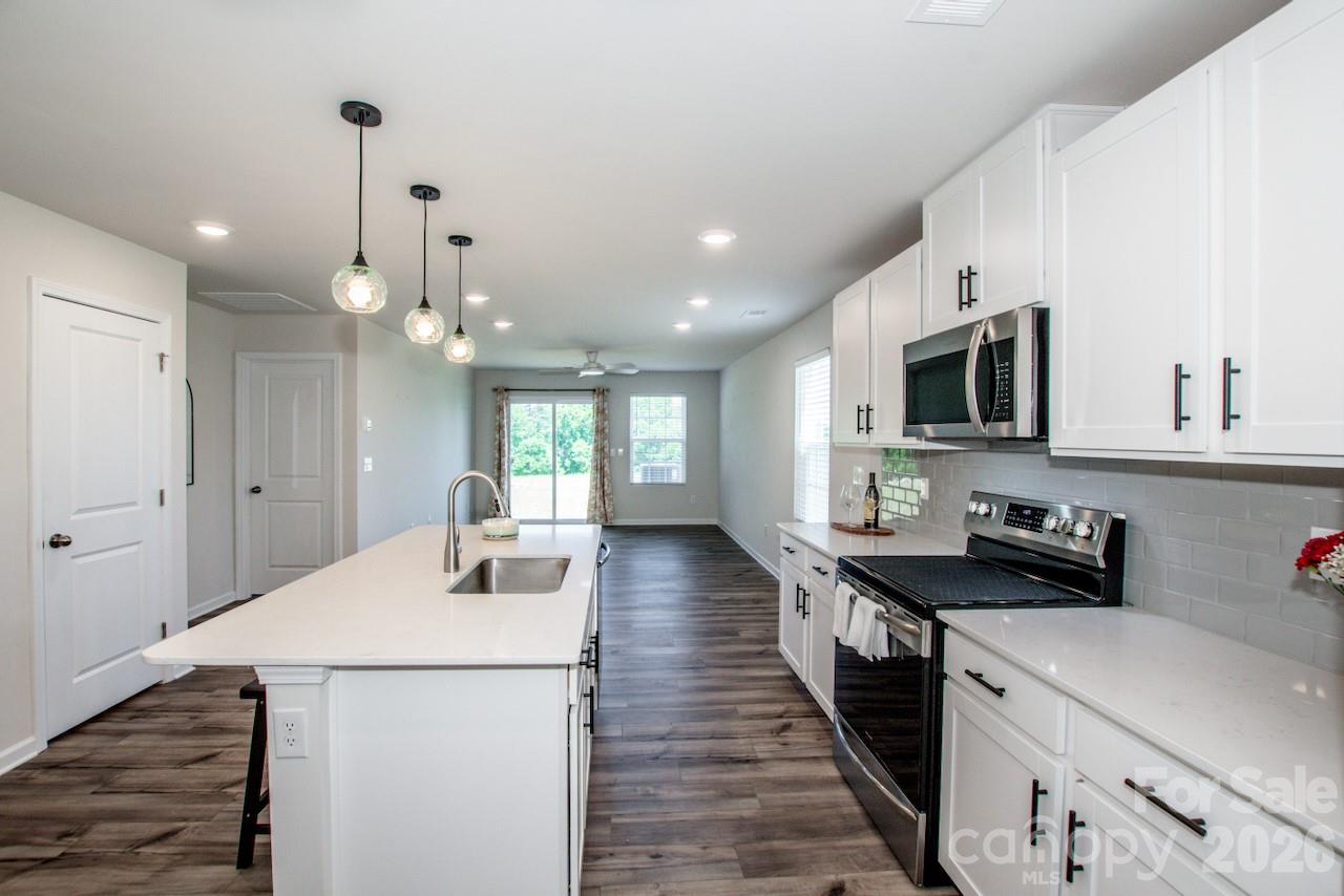 2742 Legacy Ridge Lane Catawba, NC 28609 - Photo 15 of 36 a kitchen with a sink a microwave and wooden floor