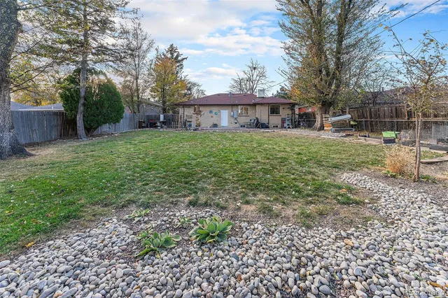a view of a house with a yard and sitting area