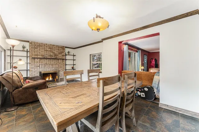 a living room with furniture a fireplace and a large window