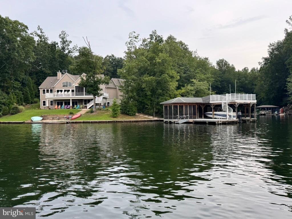 8 Elnor Road Bumpass, VA 23024 - Photo 8 of 13 Lakeside retreat surrounded by lush greenery.