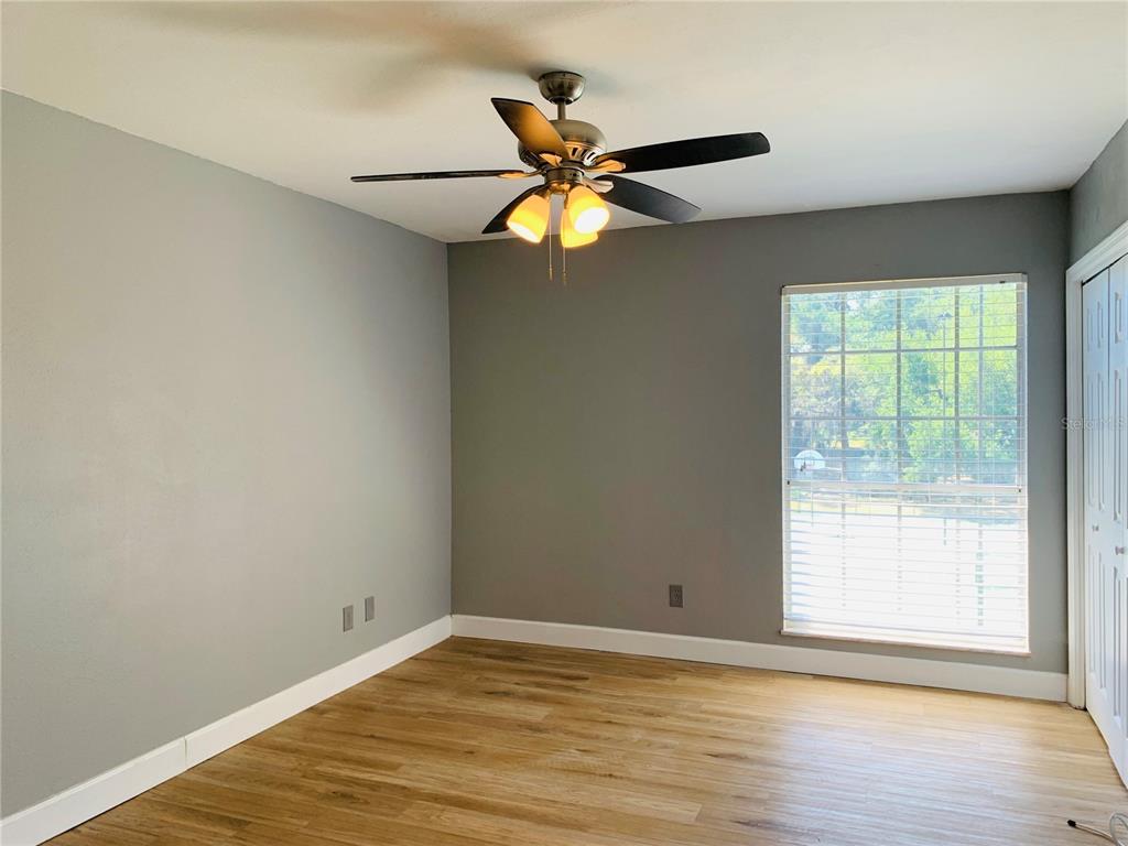435 Wymore Road, Unit 207 Altamonte Springs, FL 32714 - Photo 9 of 16 a view of an empty room with window and wooden floor