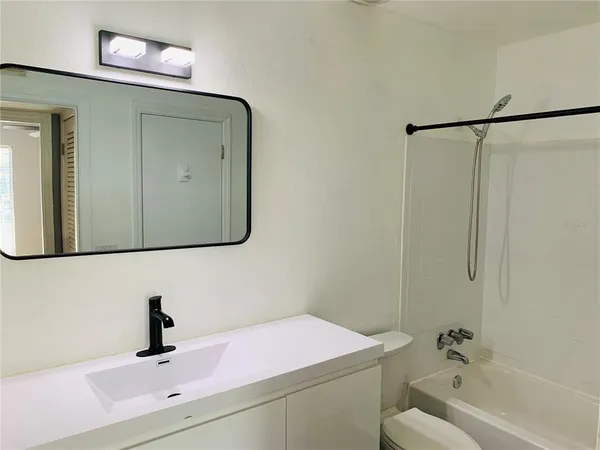 a bathroom with a sink toilet and tub