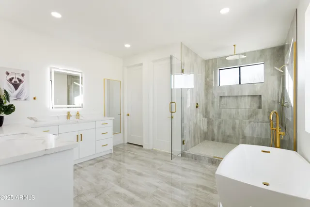 a large bathroom with a sink mirror toilet shower and bathtub