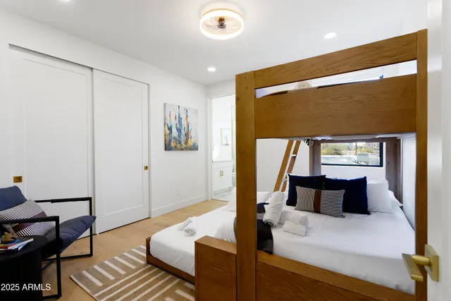 a bedroom with a bed and wooden floor