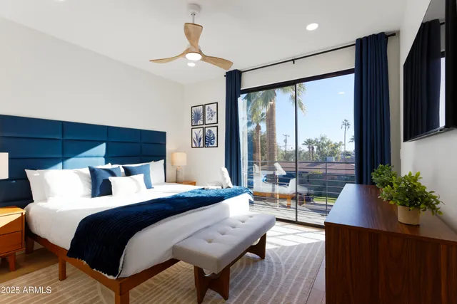 a bedroom with a bed and a large window