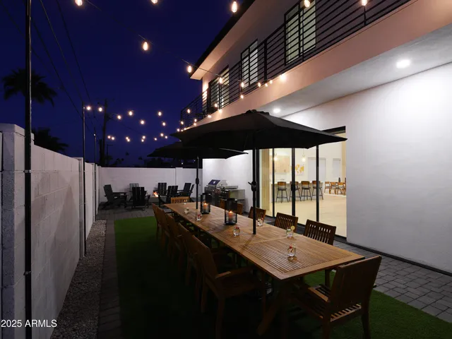 a kitchen with a sink stainless steel appliances and dining table