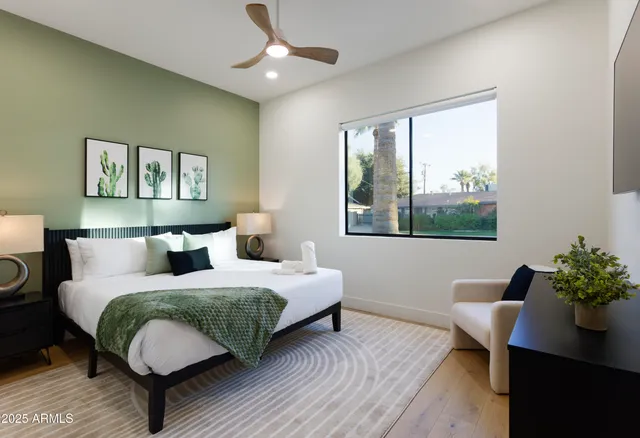 a bedroom with a bed potted plant and a window