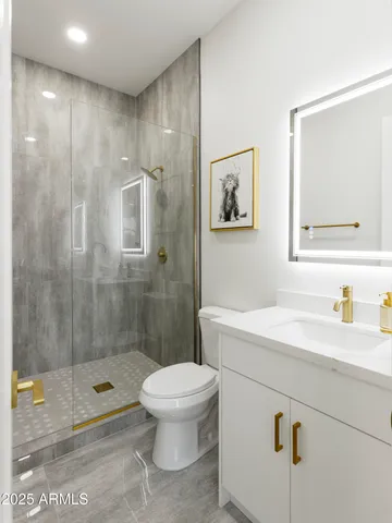 a bathroom with a sink a toilet and shower