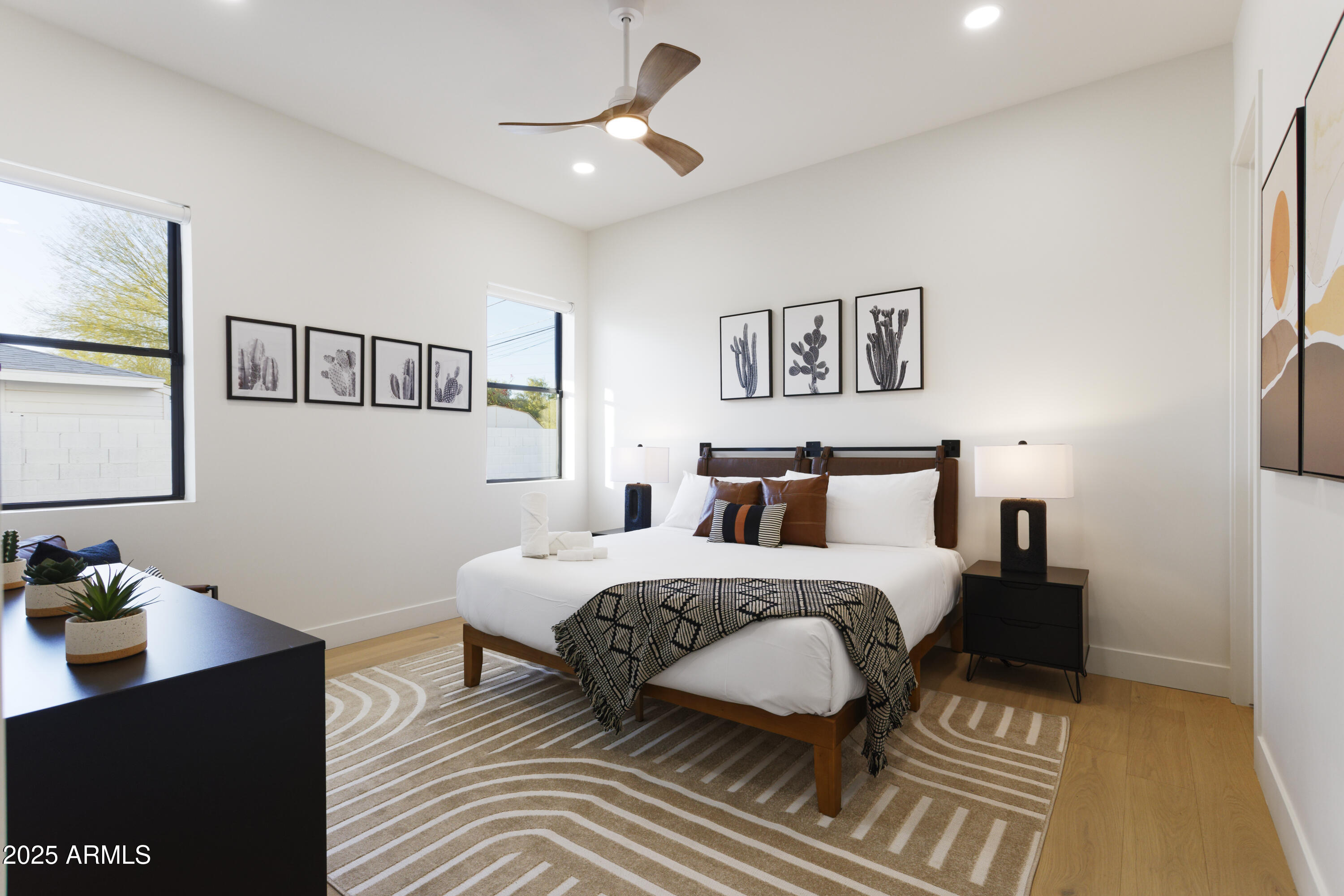 7520 East Highland Avenue Scottsdale, AZ 85251 - Photo 35 of 52 a bedroom with a bed and wooden floor