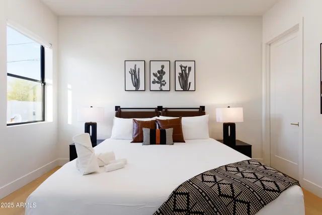 a bedroom with a large bed and a window