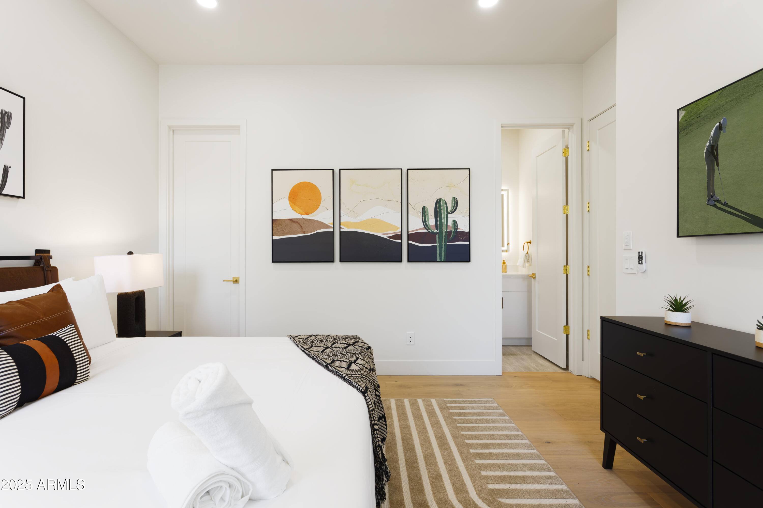 7520 East Highland Avenue Scottsdale, AZ 85251 - Photo 37 of 52 a bedroom with a bed and a flat tv screen on dresser