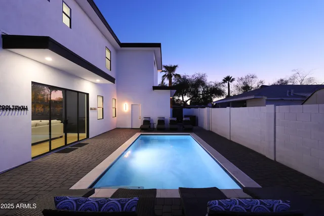 a table and chairs in patio of a house