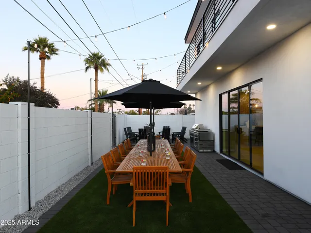 a view of a dining room with furniture and a potted plant