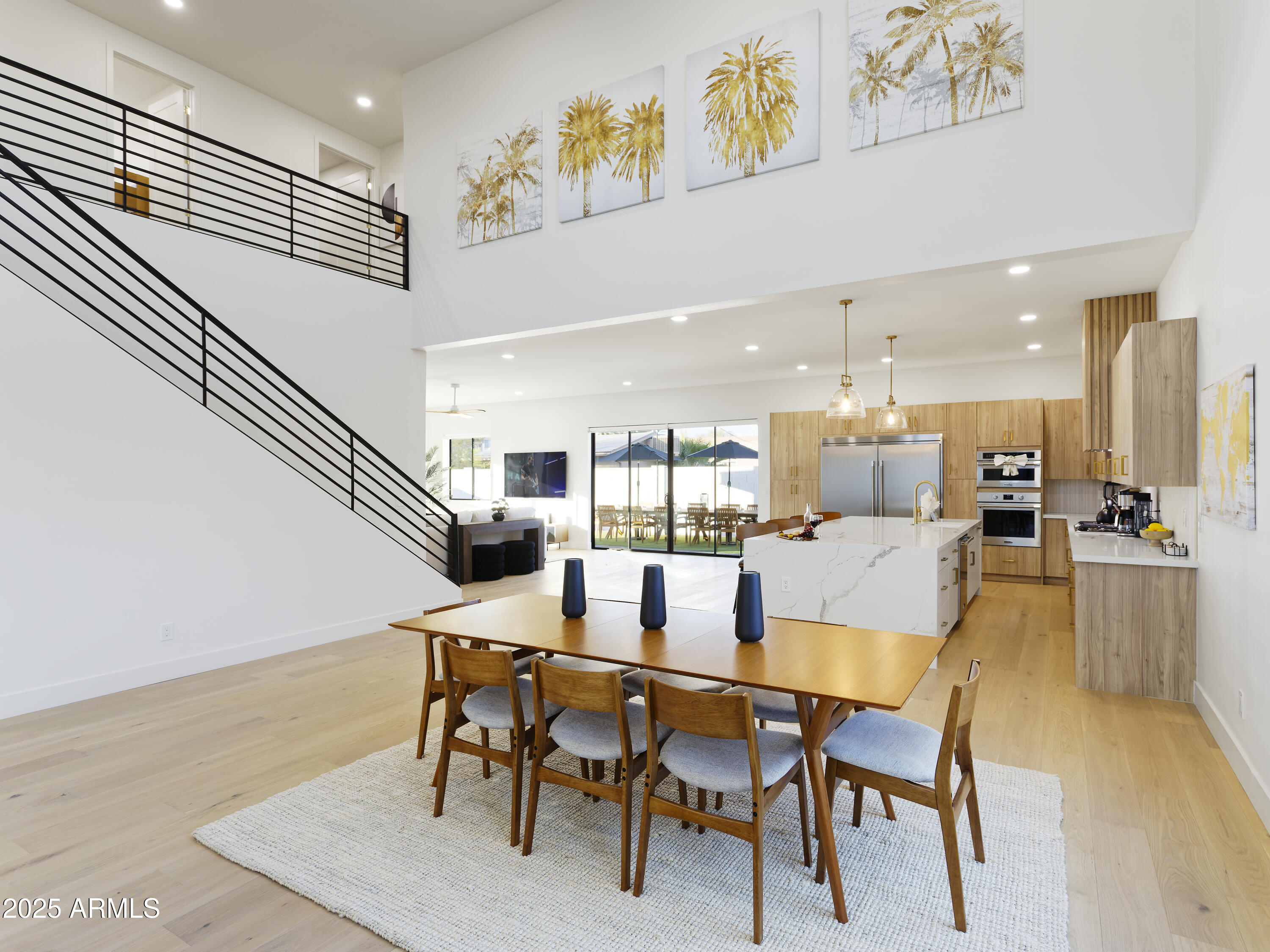 7520 East Highland Avenue Scottsdale, AZ 85251 - Photo 8 of 52 a dining room with kitchen island a table and chairs