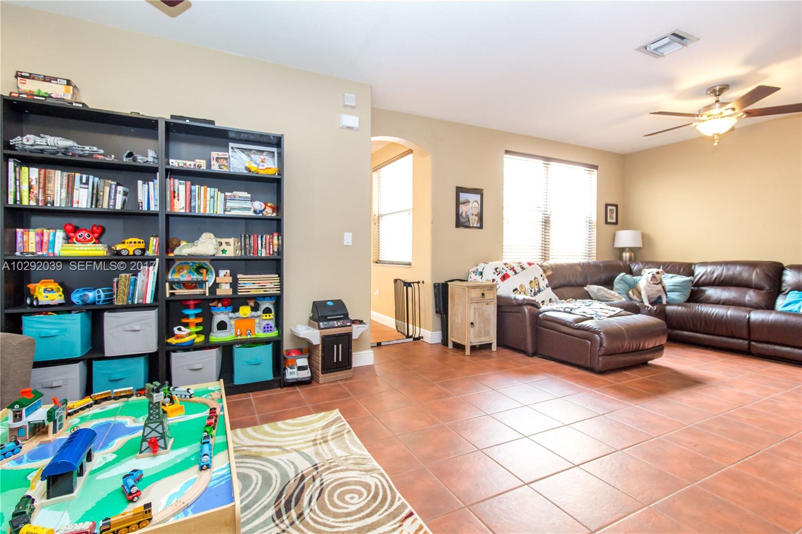 1701 Southeast 20th Road Homestead, FL 33035 - Photo 13 of 42 a living room with lots of furniture and toys