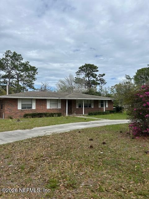 9525 Old Plank Road Jacksonville, FL 32220 - Photo 1 of 1 a front view of a house with a yard