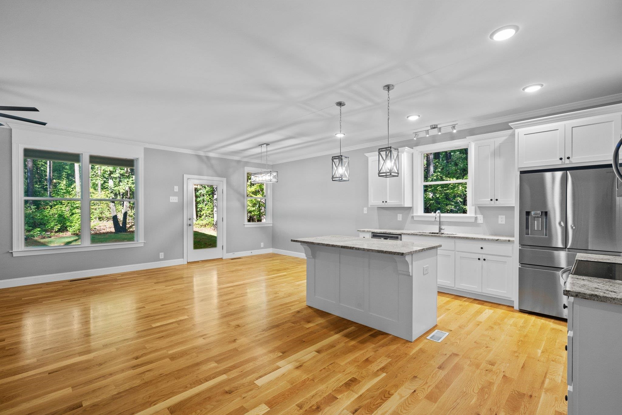 4539 Gresham Drive Oxford, NC 27565 - Photo 12 of 43 a kitchen with stainless steel appliances granite countertop a refrigerator a stove and a wooden floors