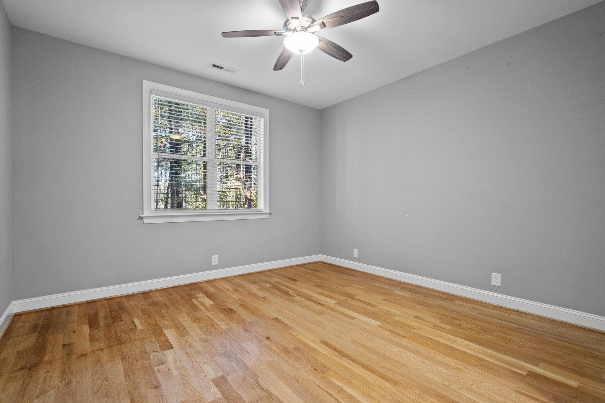 4539 Gresham Drive Oxford, NC 27565 - Photo 28 of 43 a view of an empty room with wooden floor and a window