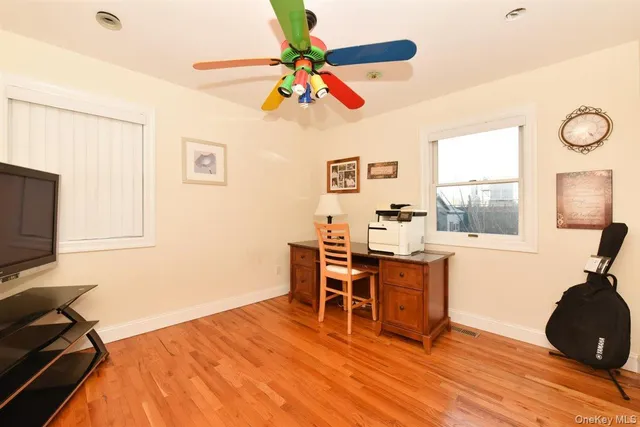 a view of a workspace with furniture and a window