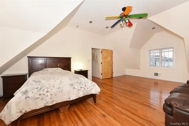 a bedroom with a bed and a painting on the wall