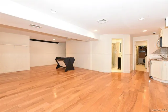 a view of a livingroom with wooden floor and a cabinet