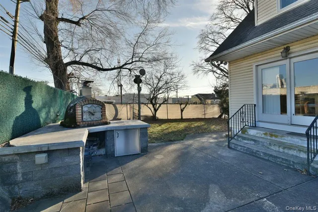 a view of a chairs setting on the deck in front of house