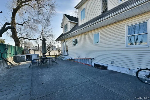 a view of a patio with table and chairs and couches