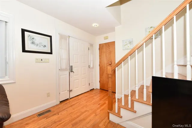 a view of an entryway with wooden floor