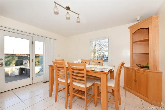 a dining room with furniture and a floor to ceiling window