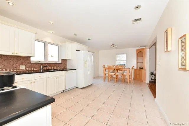 a kitchen with a table chairs and a refrigerator