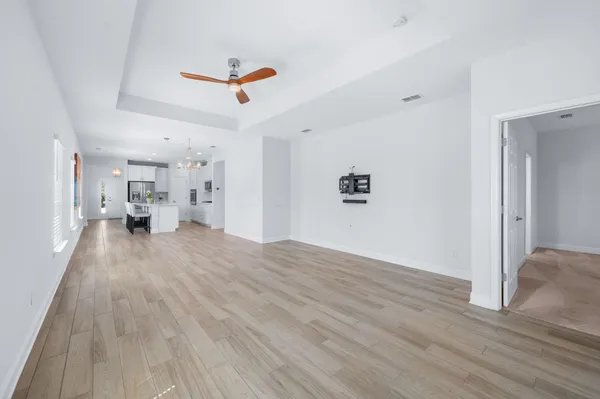 a view of empty room with wooden floor