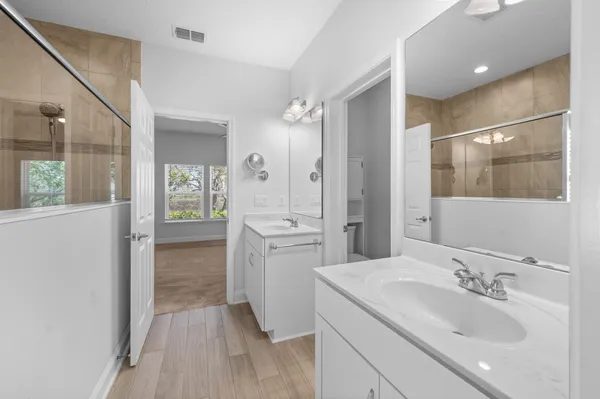 a bathroom with a sink a toilet and shower