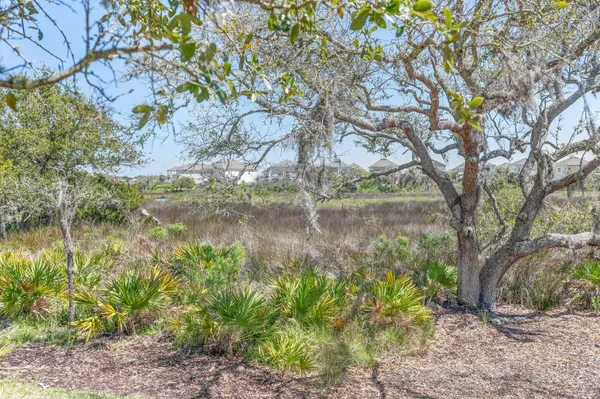an aerial view of residential houses with outdoor space and parking