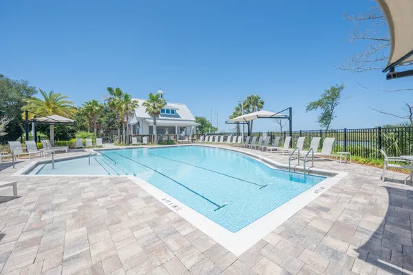 a view of a yard with a table and chairs under an umbrella
