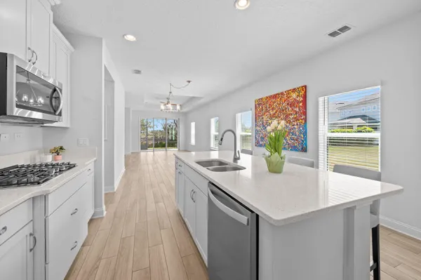 a kitchen with stainless steel appliances a sink stove and cabinets