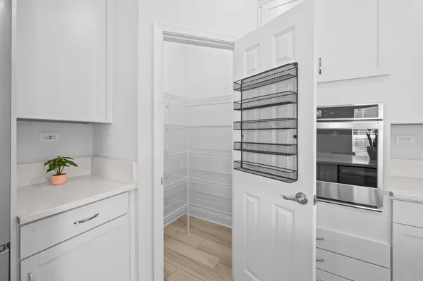 a view of walk in closet and bedroom