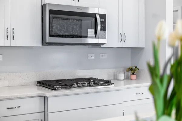a white stove top oven sitting inside of a kitchen