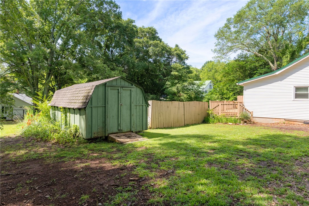 108 Tarrant Street Central, SC 29630 - Photo 31 of 42 A well-maintained shed with a gambrel roof and a fenced-in yard offers practical outdoor storage.