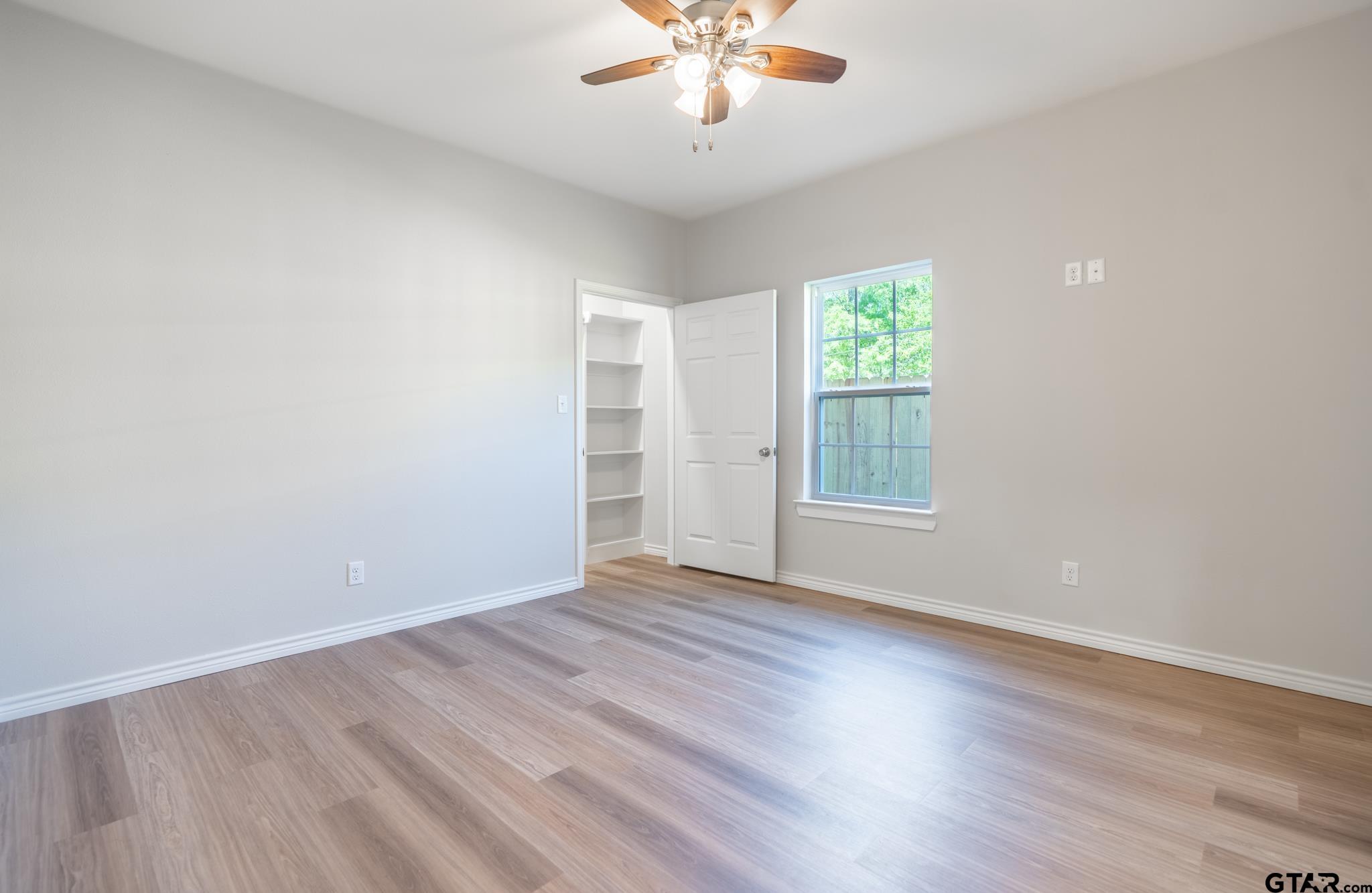 233 Harrison Street Longview, TX 75601 - Photo 20 of 44 a view of an empty room with wooden floor and a window
