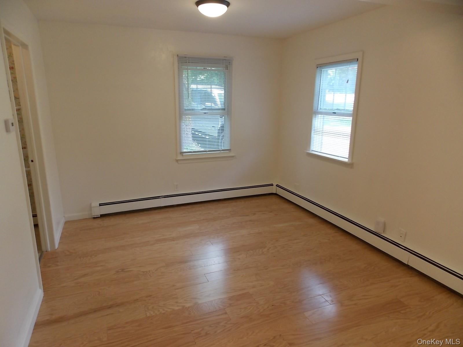 111 Lakeside Trail, Unit A Ridge, NY 11961 - Photo 6 of 7 an empty room with a window