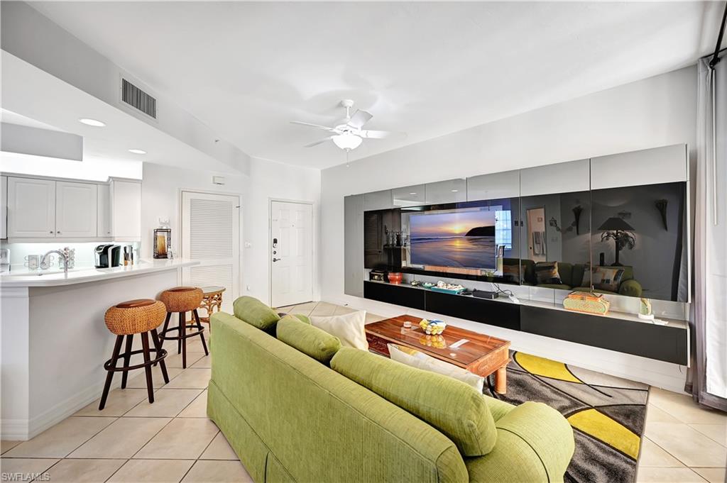 410 Bayfront Place, Unit 2409 Naples, FL 34102 - Photo 5 of 23 a living room with furniture and a flat screen tv