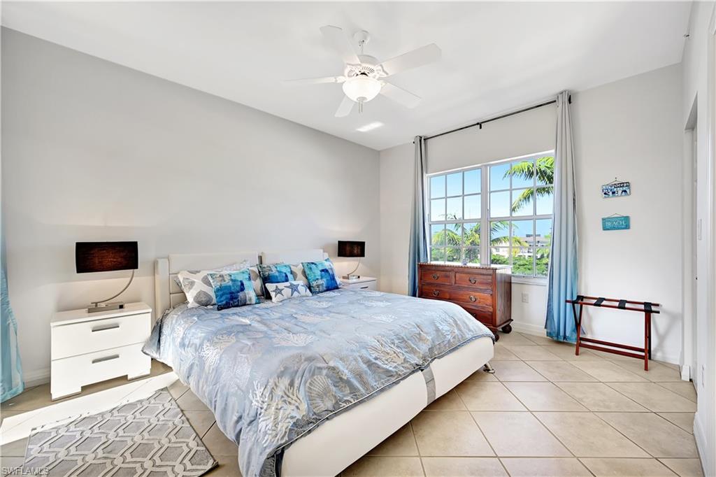 410 Bayfront Place, Unit 2409 Naples, FL 34102 - Photo 10 of 23 a bedroom with a bed and a flat tv screen on the dresser