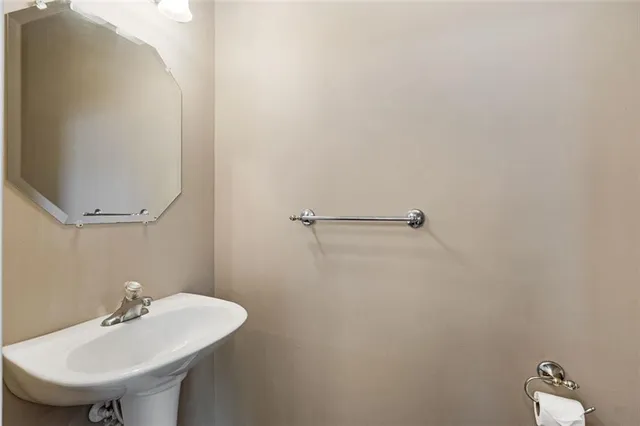 a bathroom with a sink a mirror and a toilet