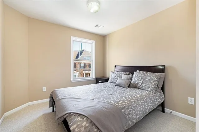 a bedroom with a large bed and a window