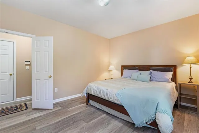 a bedroom with a bed and wooden floor