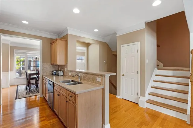 a kitchen with stainless steel appliances granite countertop a sink stove and cabinets